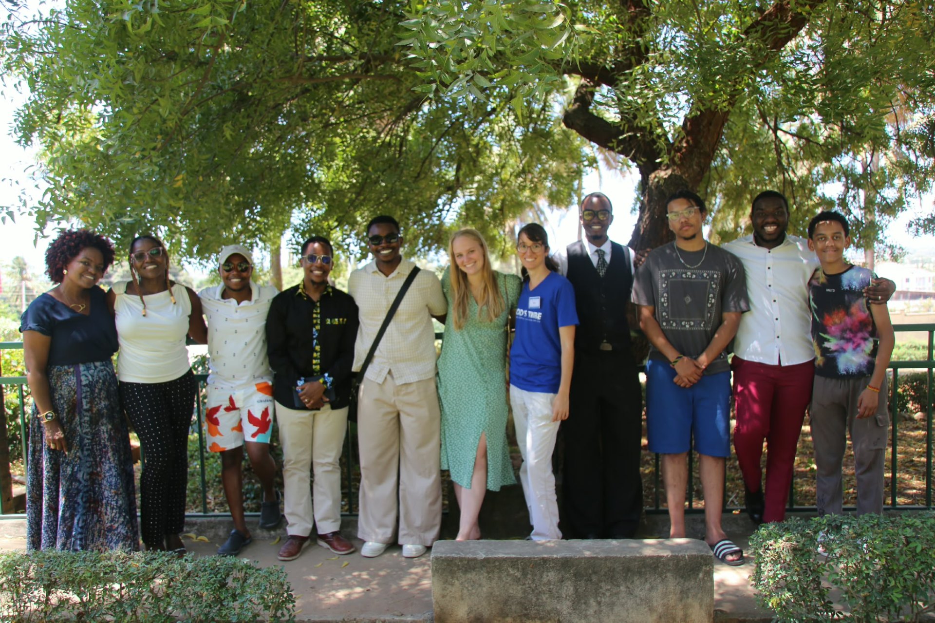 God’s Tribe friends gathered outdoors beneath a shady tree
