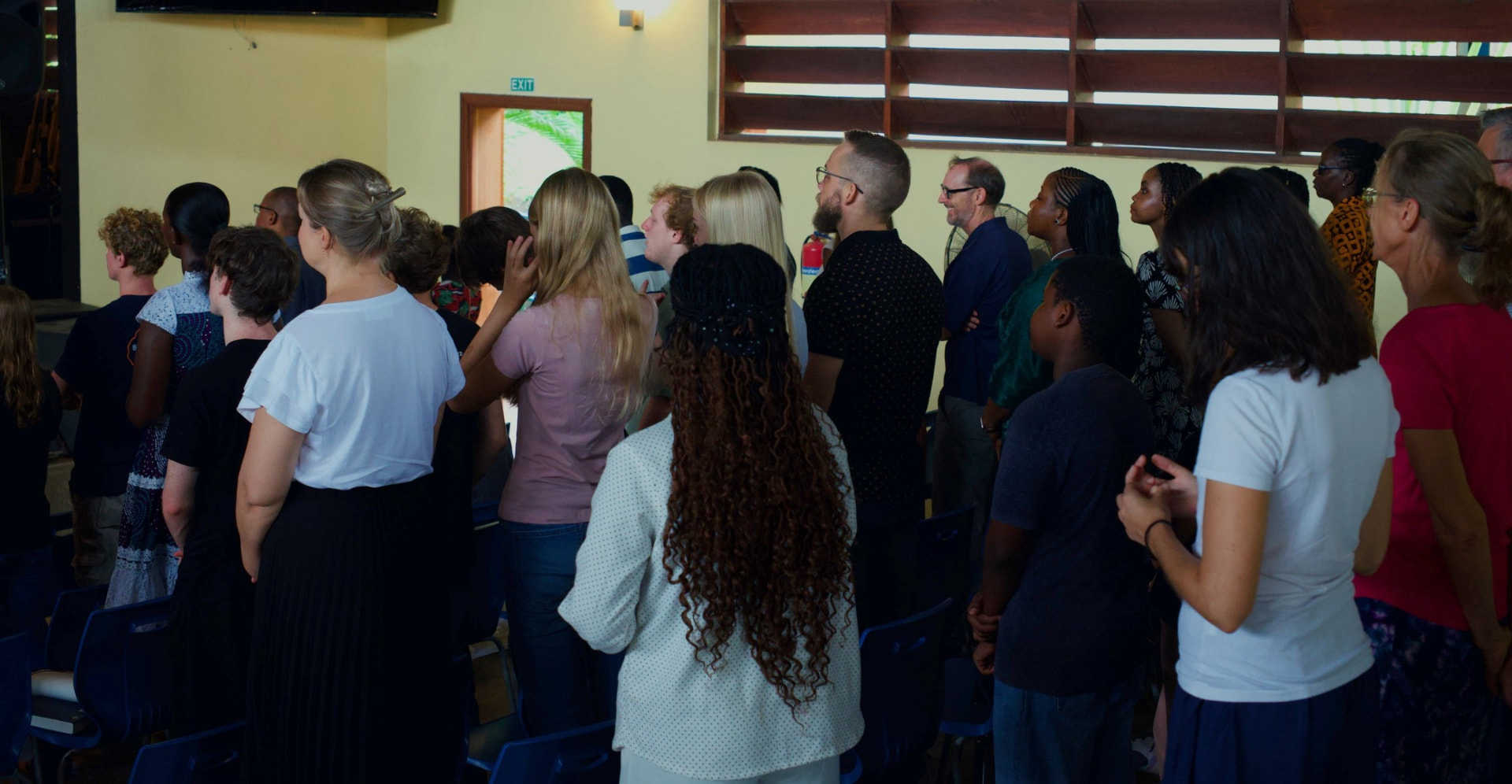 God’s Tribe Church congregation worshipping together in the hall